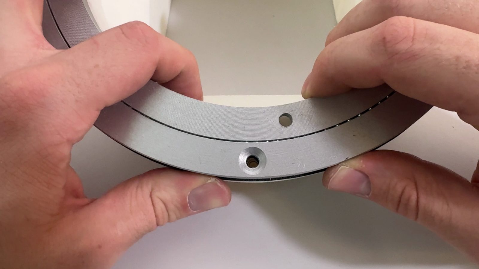 Lining up the first screw hole with the chute mount's heat insert