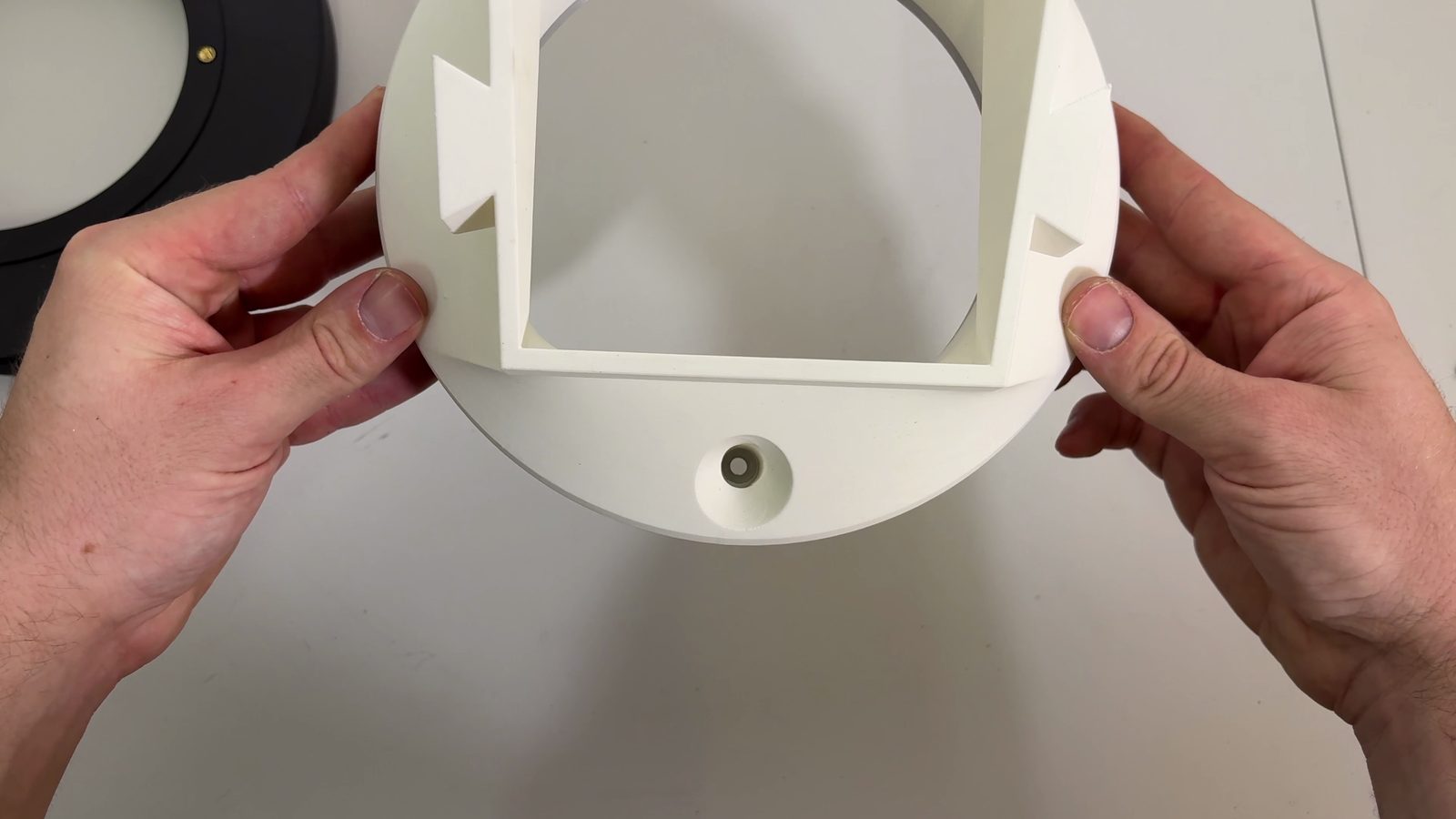 Pass-through hole in the chute mount with the screw reachable underneath