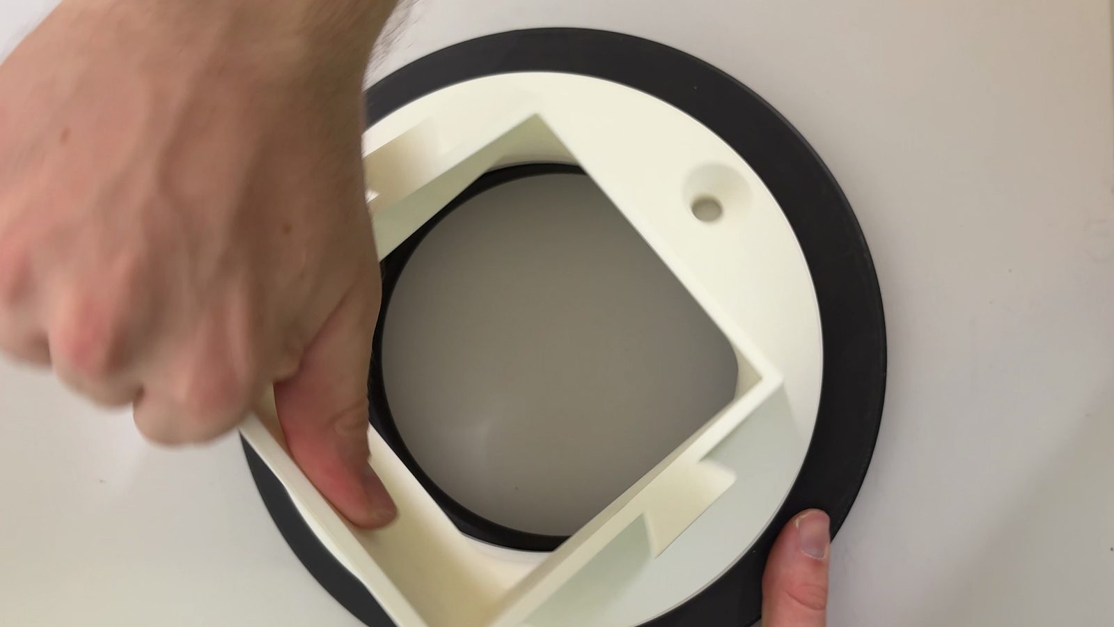 Rotating the chute with the Lazy Susan to the next screw position