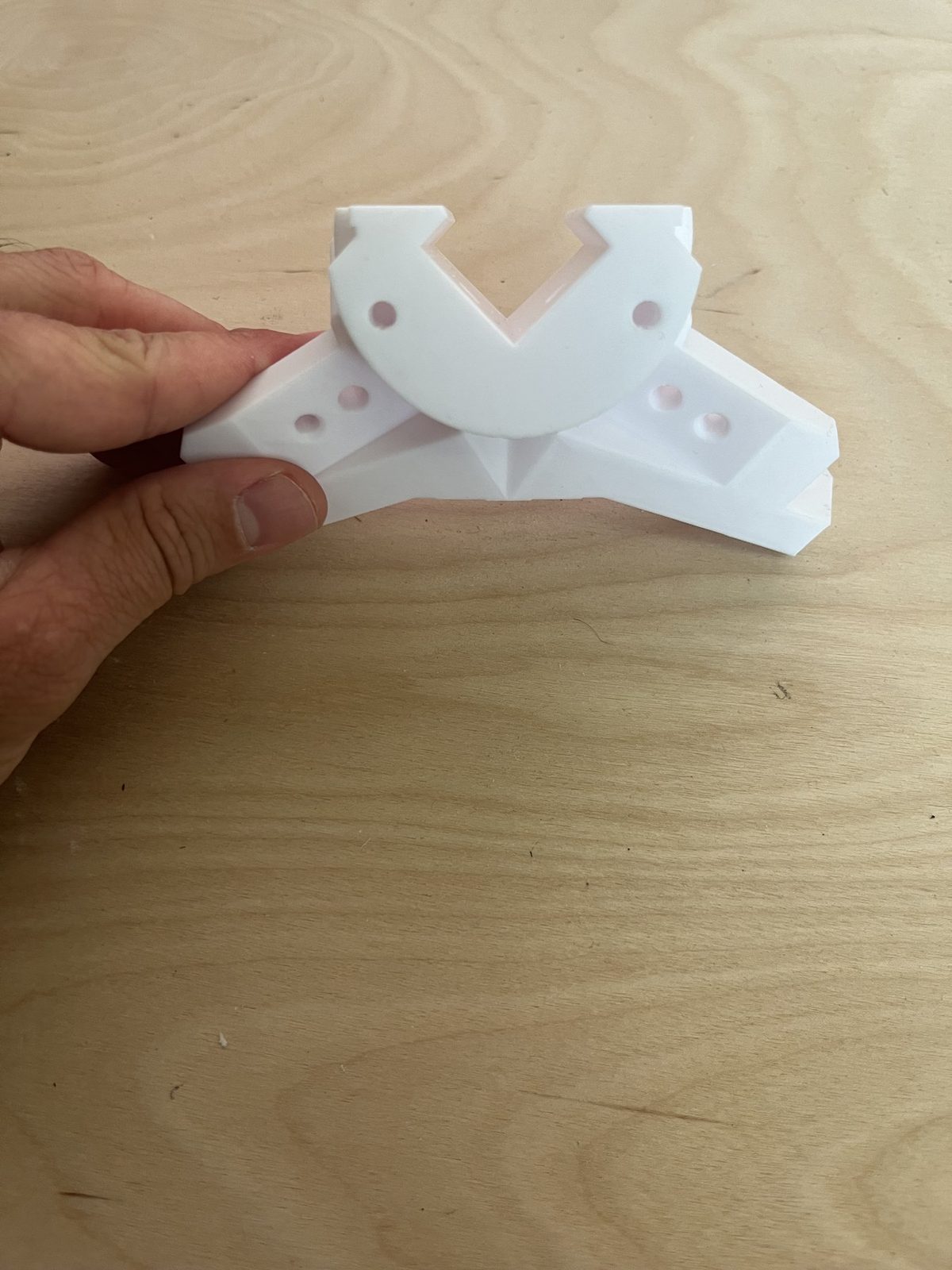Close-up of the side bracket alone, showing the U-shaped extrusion clamp and the two mounting-hole wings