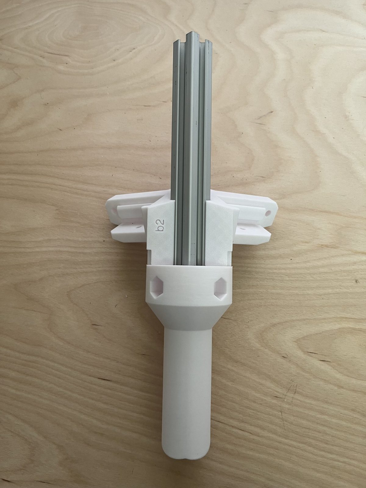 C-Layer vertical support extrusion inserted down through the side bracket and into the square socket of the bottom-vertical leg