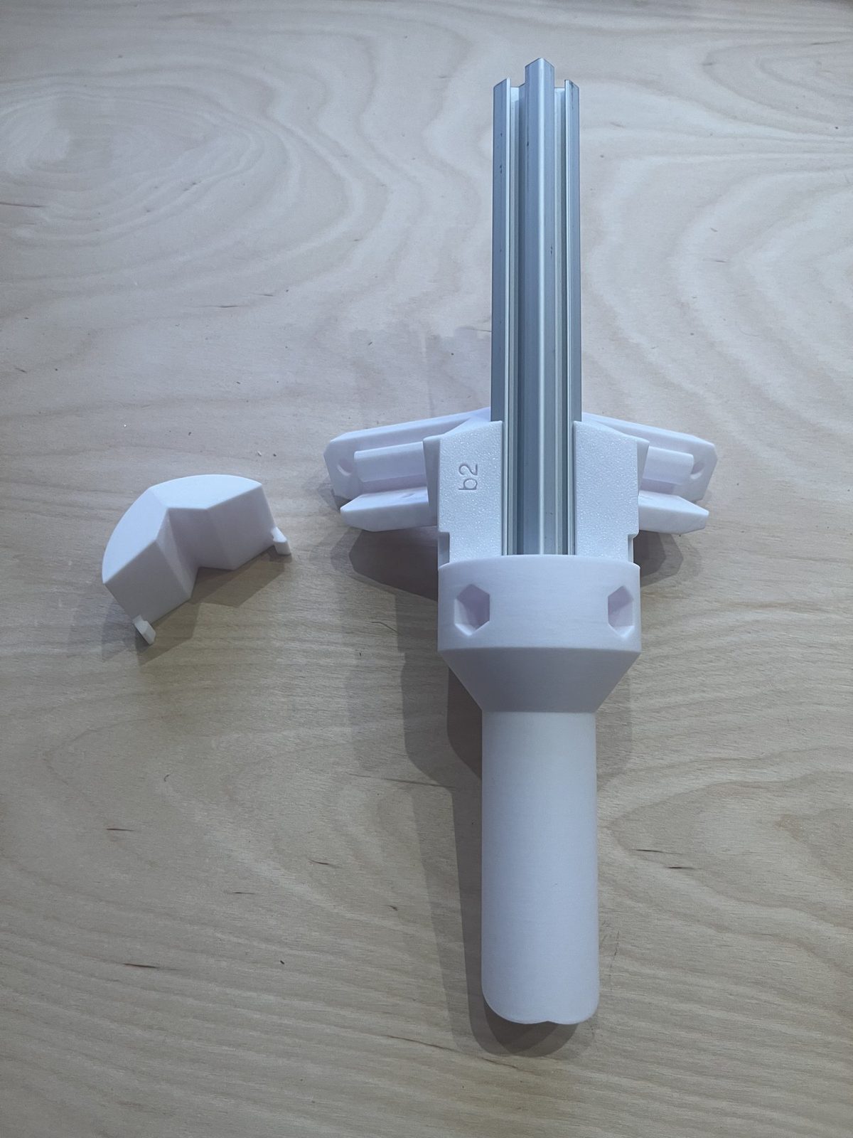The unattached cover sitting next to the assembled bracket, at the face where it clips on