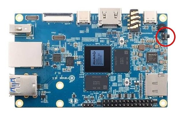 Orange Pi 5 board with the side power button circled in red